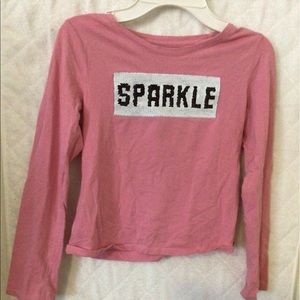Pink long sleeved shirt.
